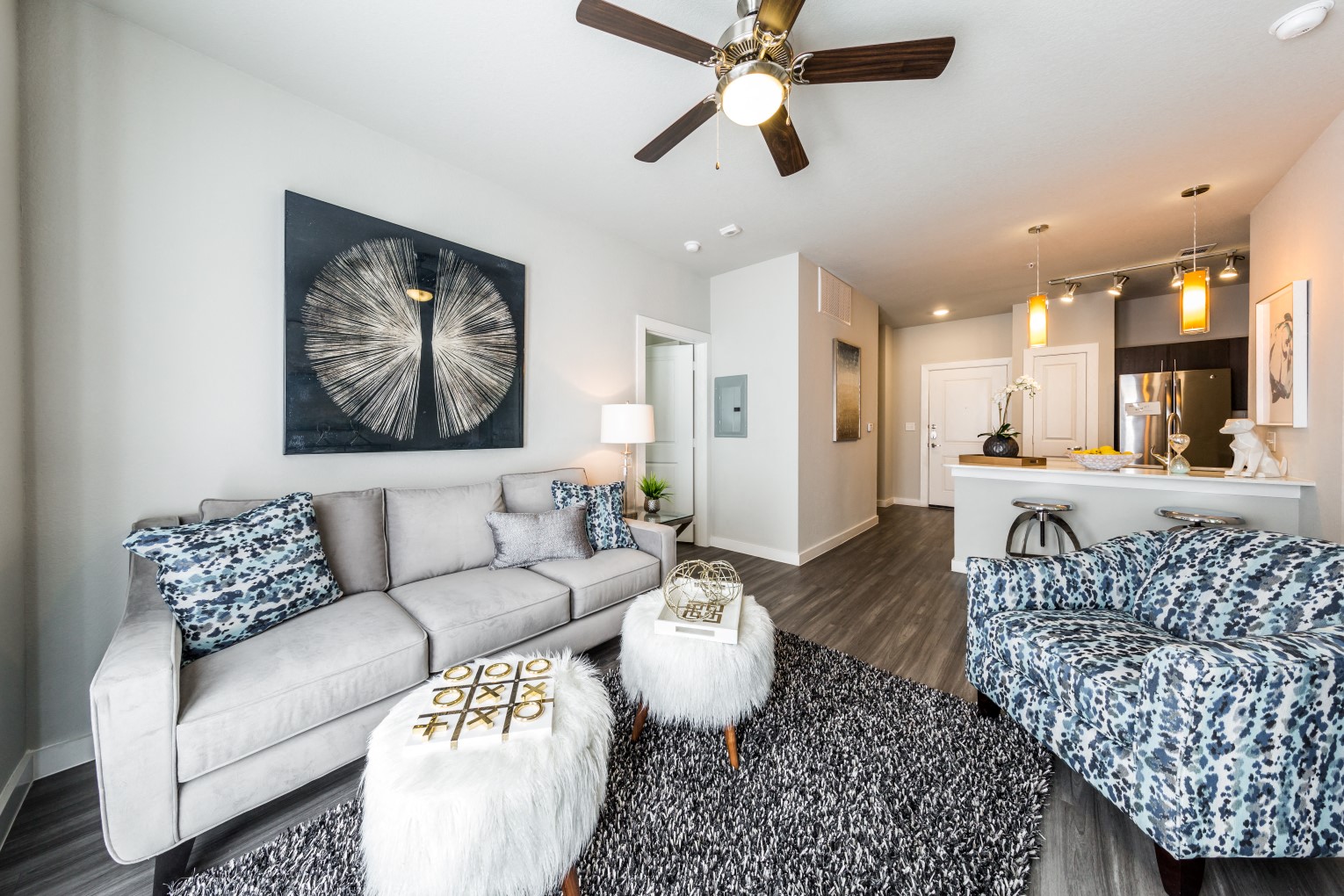 a living room with a couch and a ceiling fan